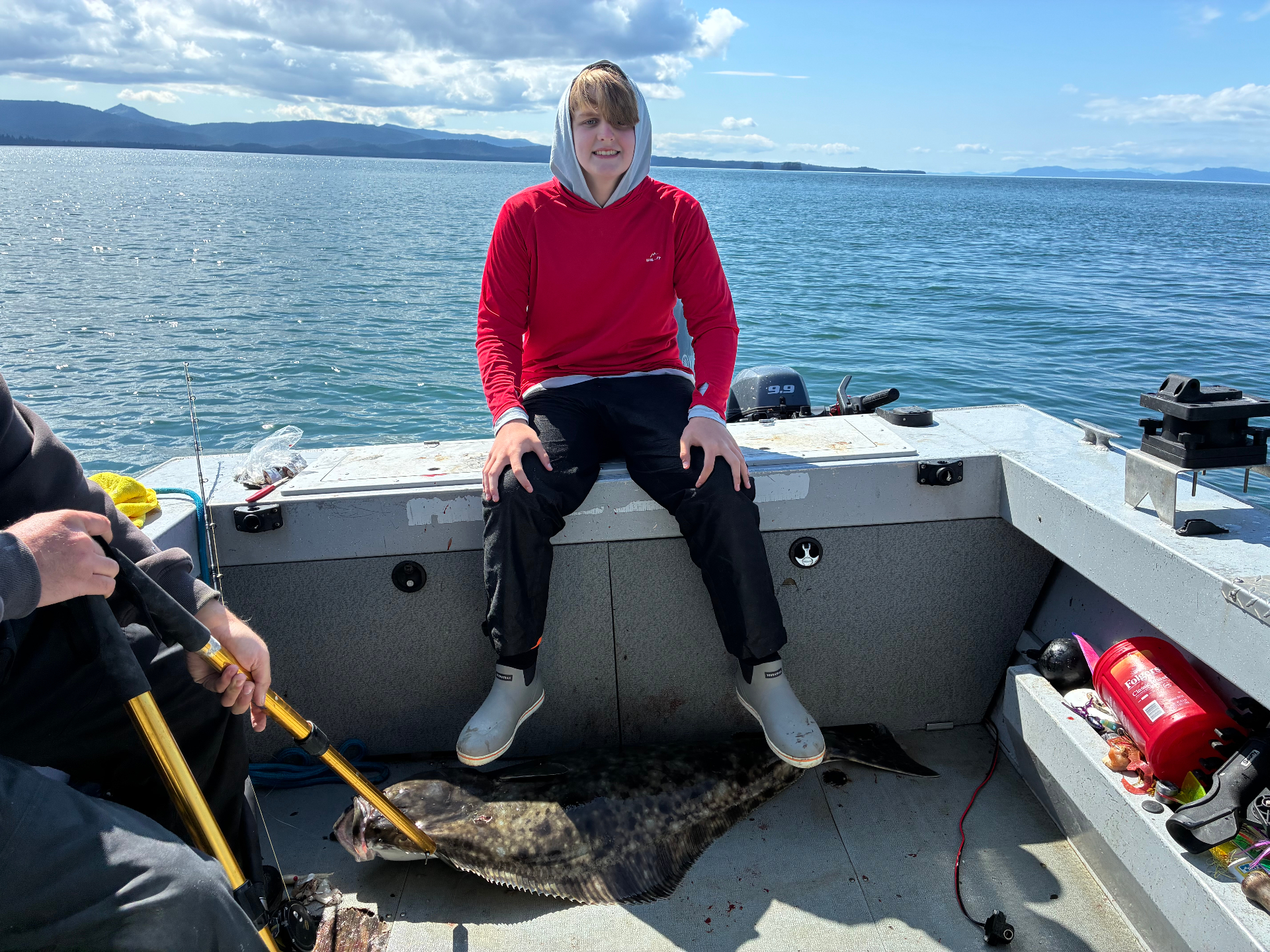 Guest holding a halibut caught in Clarence Strait near Coffman Cove